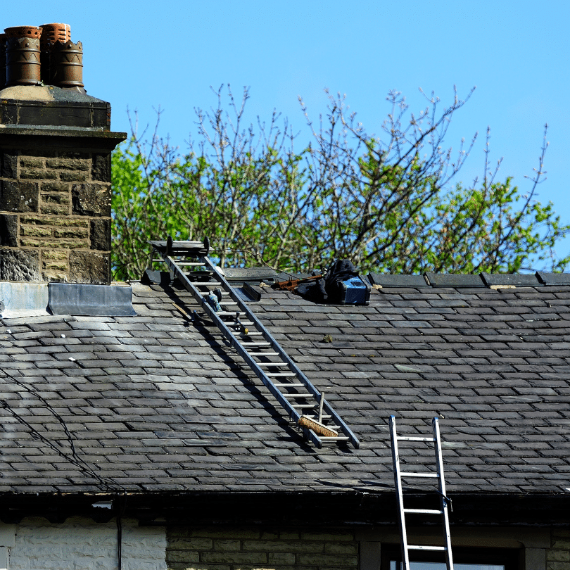 cottage getting chimney breast removed with man on ladder