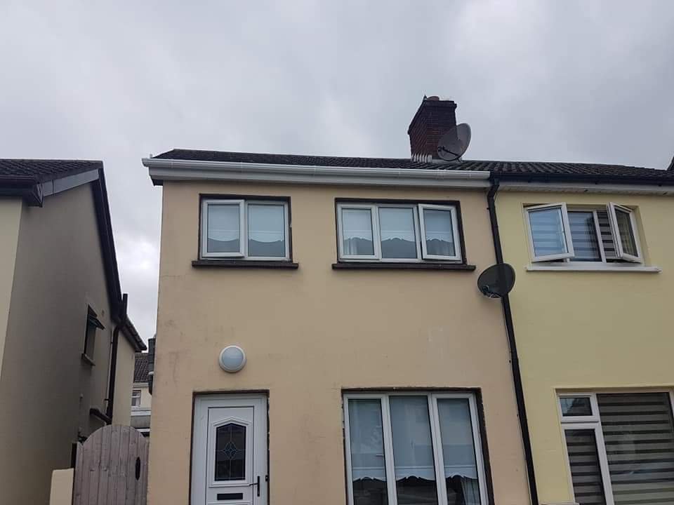 white pvc gutters on yellow house in dublin city